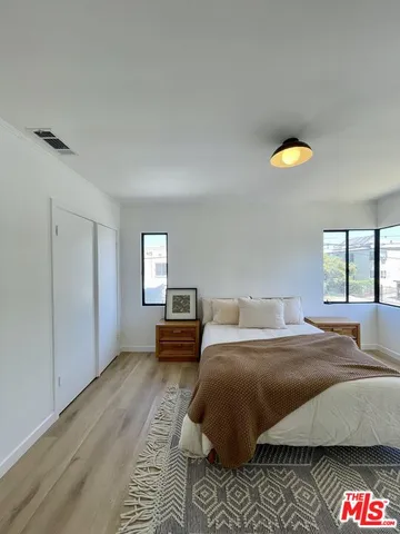 a bedroom with a bed and a cabinets