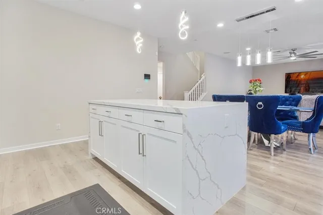 a view of a kitchen with cabinets and wooden floor