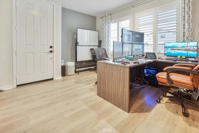 a view of a workspace with furniture and a window