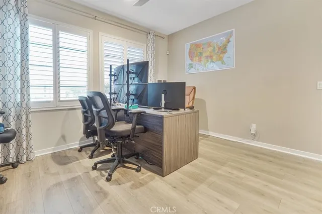 a view of a workspace with furniture and a window