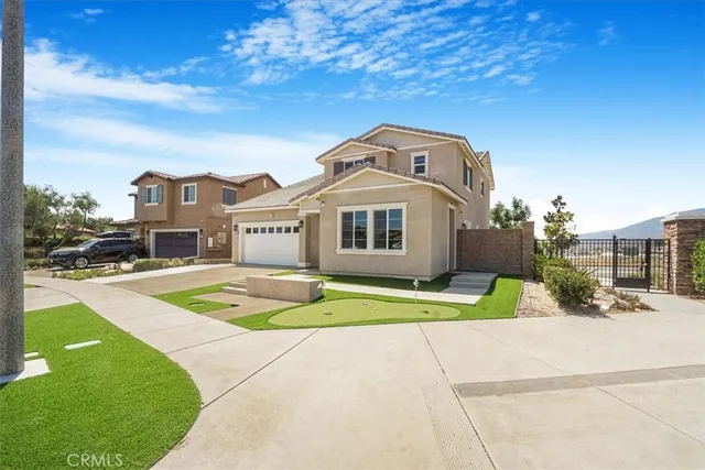 a view of a white house with a big yard and large trees