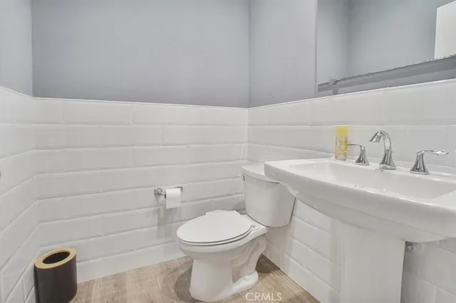 a bathroom with a toilet a sink and mirror