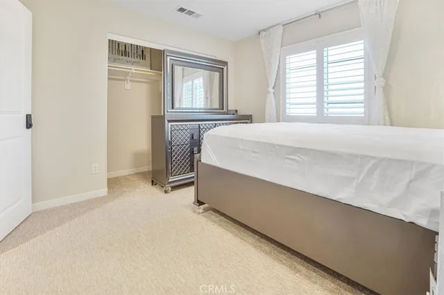 a spacious bedroom with a bed and a window