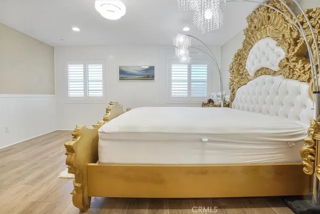 a bedroom with a bed and wooden floor