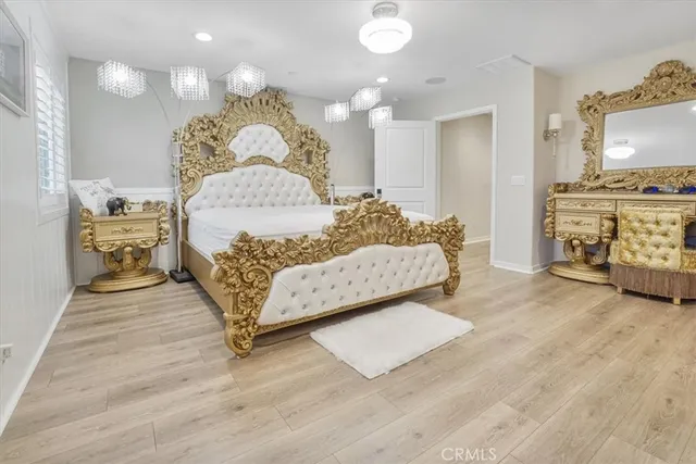 a living room with a bed furniture and a flat tv screen