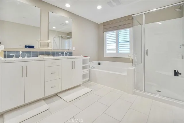 a bathroom with a bathtub a sink and a shower