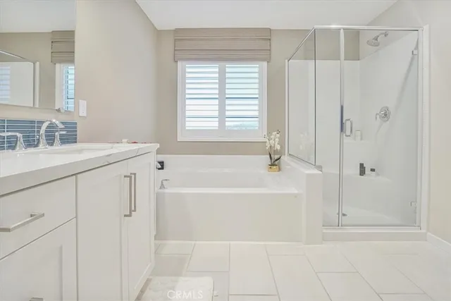 a spacious bathroom with a bathtub and a sink