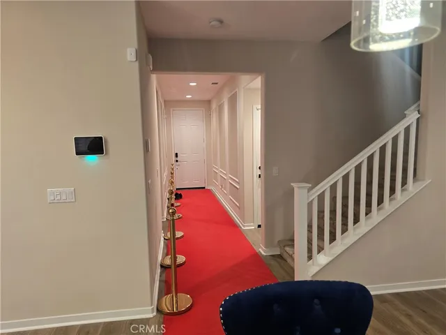 a view of a hallway with windows and wooden floor