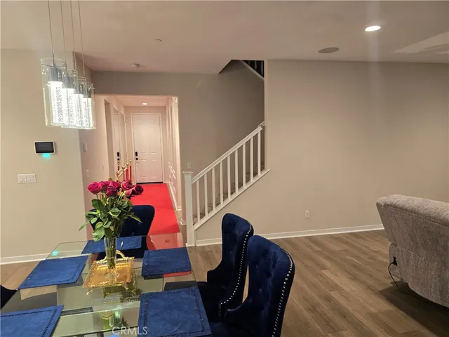 a view of a livingroom with furniture a potted plant and wooden floor
