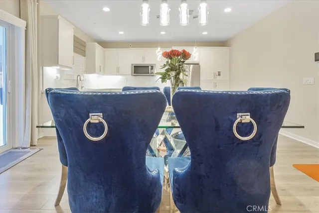 a dining room with furniture and a wooden floor