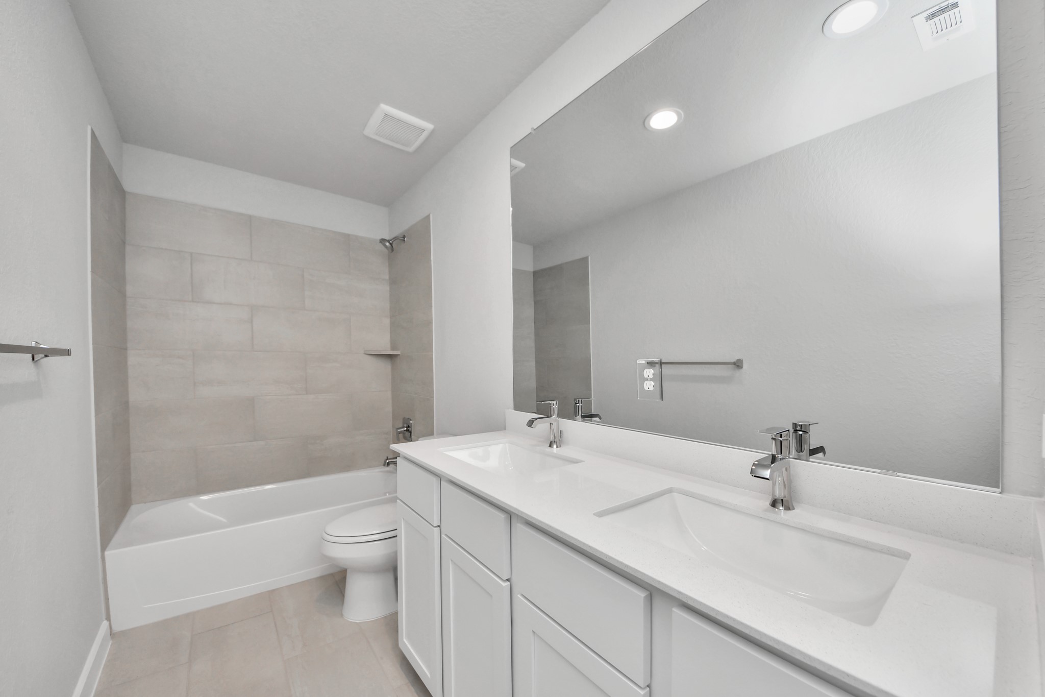 11114 Tulip Rdg Trail Houston, TX 77044 - Photo 27 of 30 Secondary bath features tile flooring, bath/shower combo with tile surround, light stained wood cabinets, beautiful light countertop. Sample photo of completed home with similar floor plan. Actual colors and selections may vary.