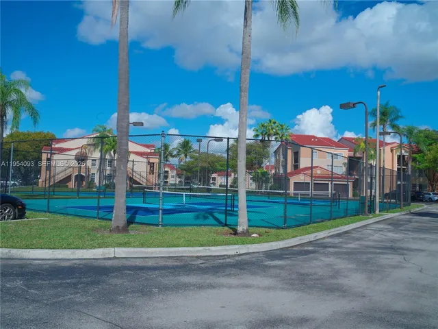a view of a house with a backyard and plants