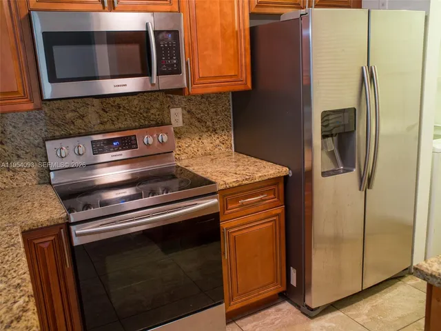 a kitchen with a stove microwave and refrigerator