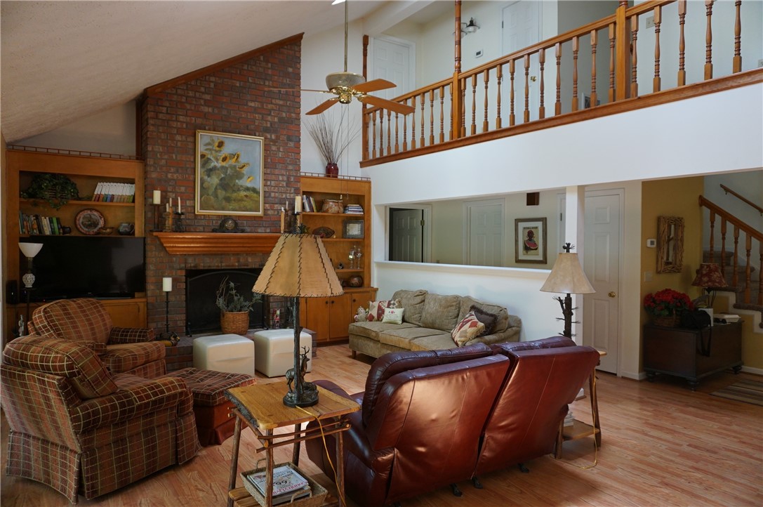 Vaulted Great Room with skylights, built-in book c