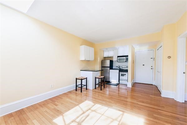 511 Beacon Street, Unit 12 Boston, MA 02215 - Photo 2 of 7 a view of kitchen with furniture and wooden floor