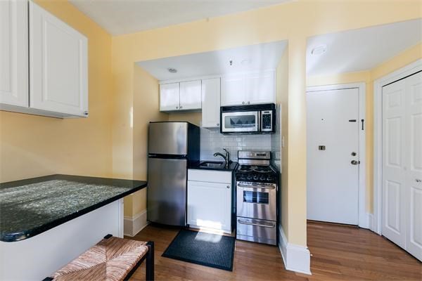 511 Beacon Street, Unit 12 Boston, MA 02215 - Photo 3 of 7 a kitchen with stainless steel appliances granite countertop a refrigerator and a stove top oven