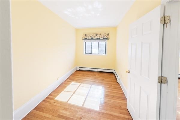 511 Beacon Street, Unit 12 Boston, MA 02215 - Photo 5 of 7 a view of a hallway with wooden floor and a large window