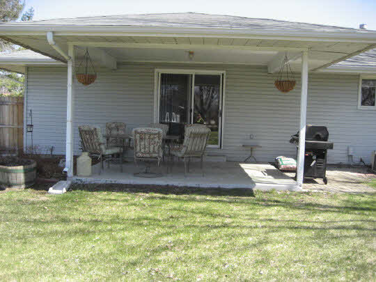 4075 Valerie Road Roscoe, IL 61073 - Photo 10 of 11 a view of backyard of house with outdoor seating