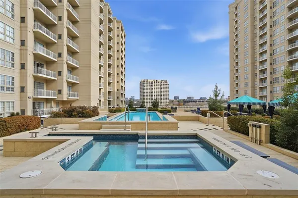 a view of a swimming pool with outdoor seating