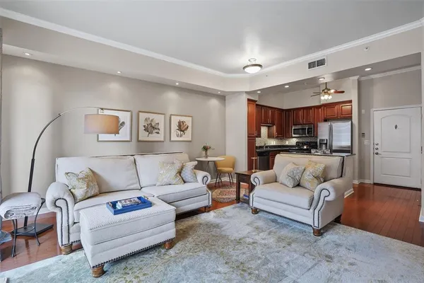 a living room with furniture and kitchen view