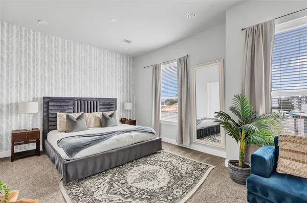 a bedroom with a large bed and a couch