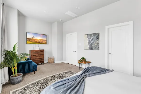 a bedroom with a bed and a couch