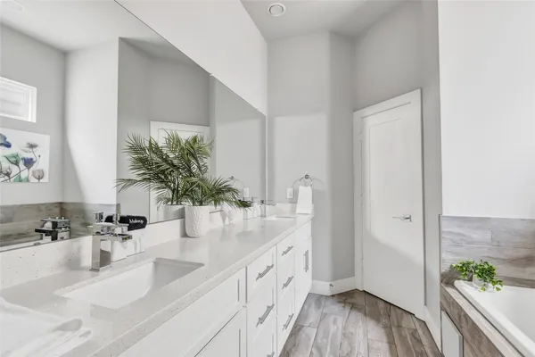 a bathroom with a double vanity sink and a mirror