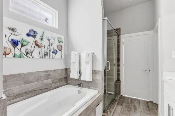 a bathroom with a bathtub and a shower