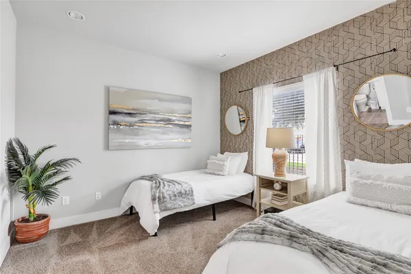 a bedroom with bed and a potted plant