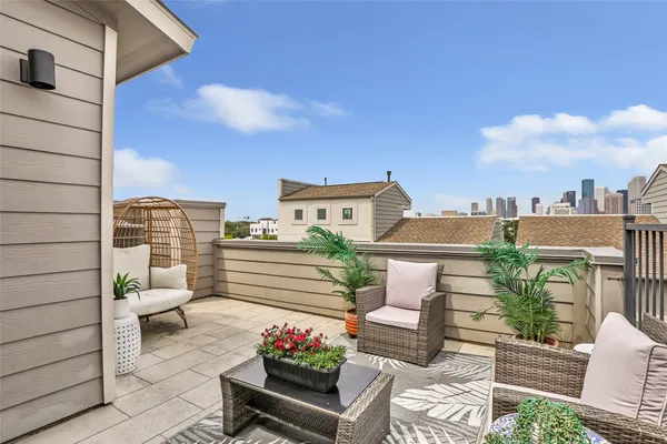 a view of a patio with couches and potted plants