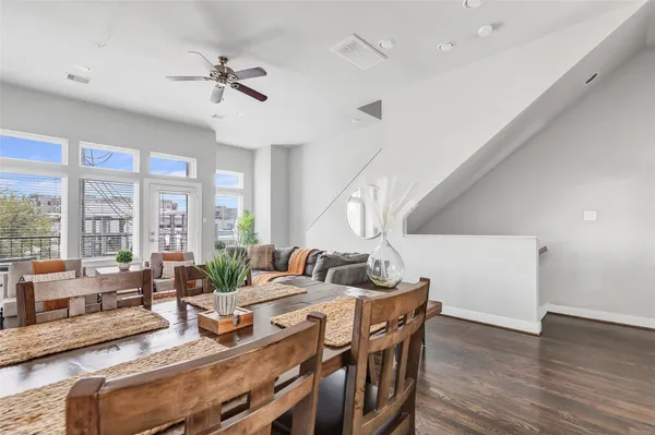 a living room with furniture and floor to ceiling windows