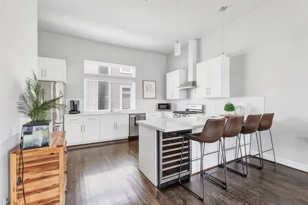 a living room with kitchen island furniture and a wooden floor