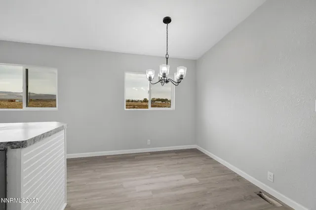an empty room with window and ceiling fan