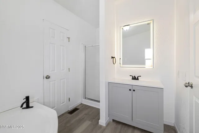 a white toilet sitting next to a bathroom sink and vanity