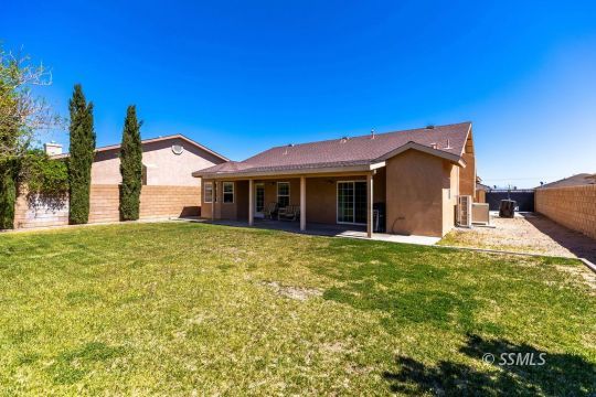 409 Acacia Street Ridgecrest, CA 93555 - Photo 34 of 34 a view of a house with a yard and garage
