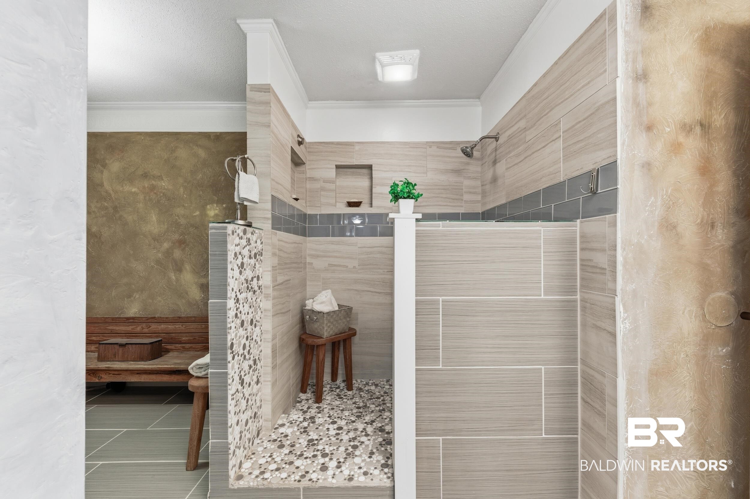 51620 Robert White Road Bay Minette, AL 36507 - Photo 44 of 81 Walk-in shower featuring a pebble-tiled floor, a built-in niche, and a contrasting gray accent tile band