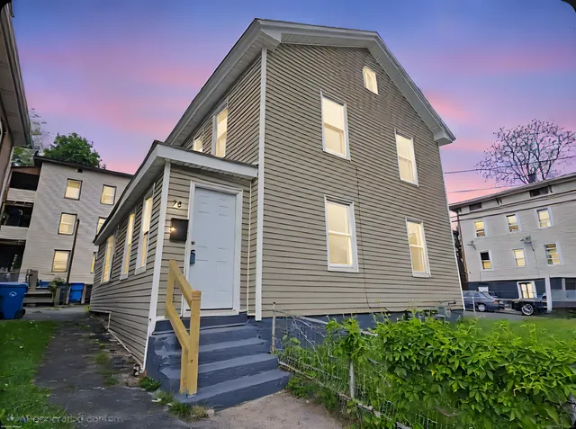 a front view of a house with a yard