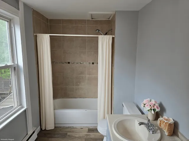 a bathroom with a tub and a sink