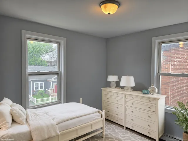 a bedroom with a bed and window