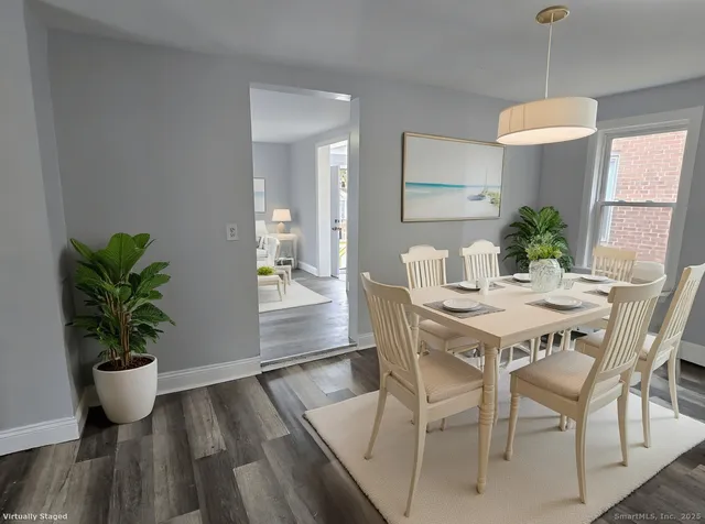 a view of a dining room with furniture and wooden floor
