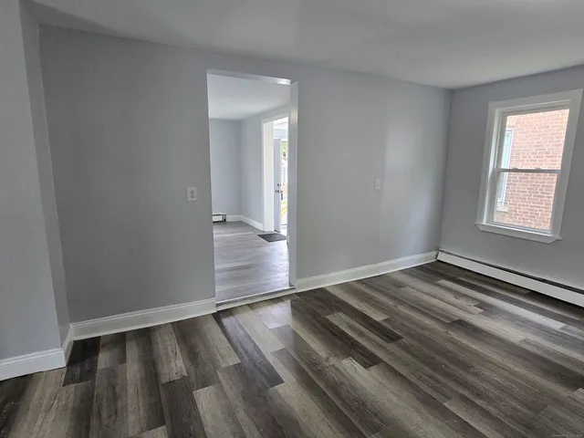 wooden floor in an empty room with a window