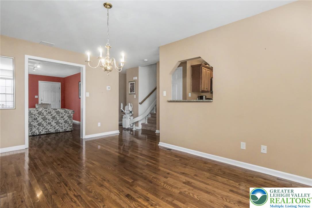 2132 Lexington Avenue Bethlehem, PA 18017 - Photo 12 of 47 a view of a livingroom with wooden floor and a chandelier