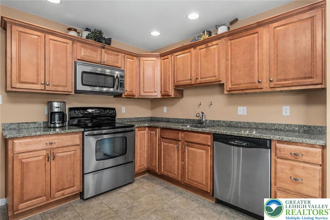 2132 Lexington Avenue Bethlehem, PA 18017 - Photo 16 of 47 a kitchen with stainless steel appliances granite countertop a sink stove and microwave