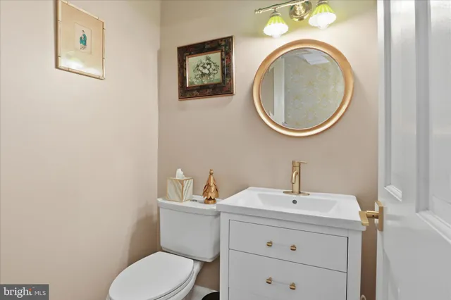 a bathroom with a toilet a sink and a mirror