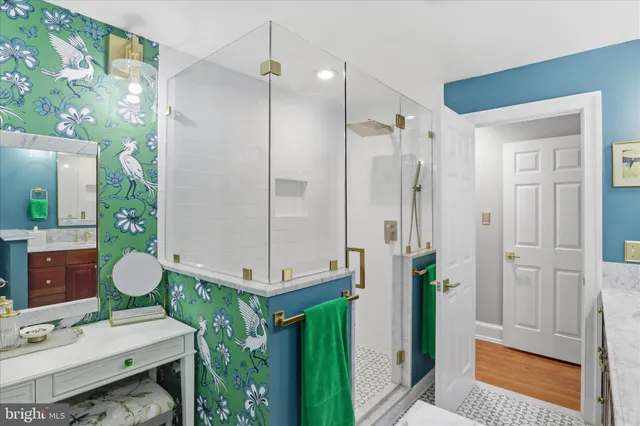 a bathroom with a mirror a sink and a shower