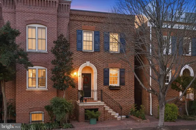 a view of a dining room with furniture a chandelier and wooden floor
