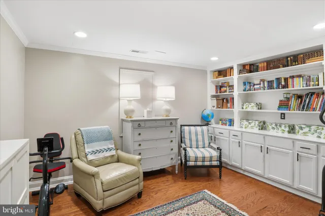 a view of a livingroom with entryway and a flat screen tv