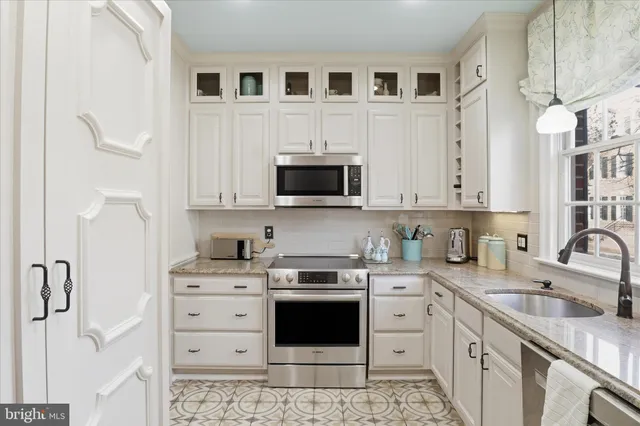 a hallway with a flower pot and a bookshelf