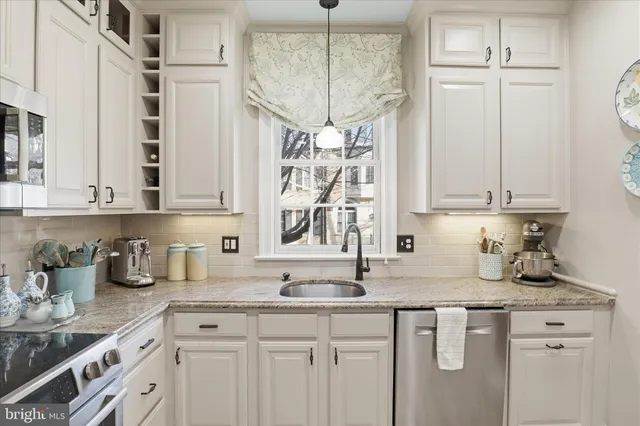 a kitchen with stainless steel appliances a stove microwave and cabinets