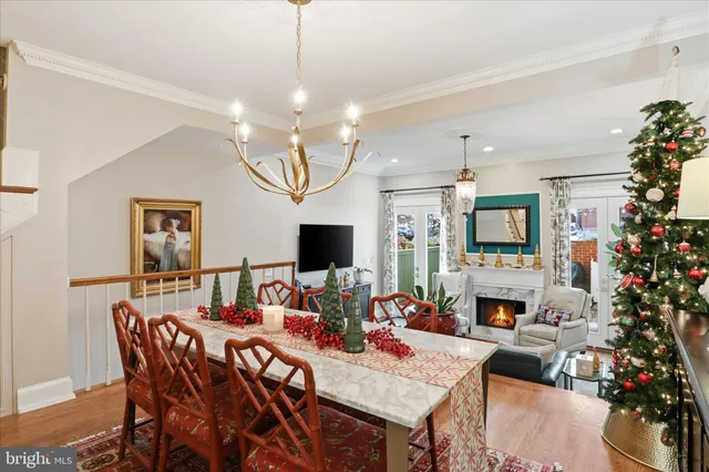a view of a dining room with furniture wooden floor and chandelier